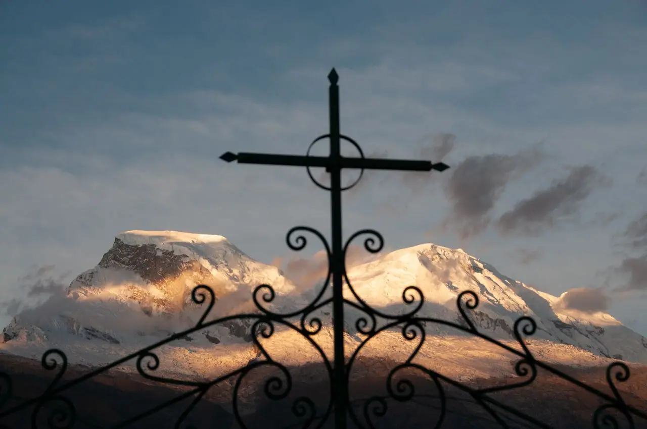 Cross at Yungay’s cemetery with Huascarán lit up behind it